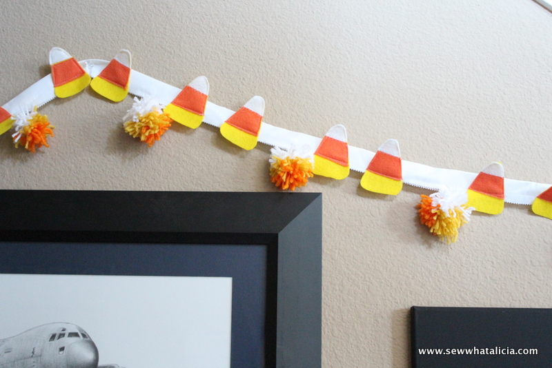 Candy Corn and Pom Pom Bunting Tutorial: This is a great sewing project for beginners. Decorate for Halloween with this quick and easy candy corn bunting. | www.sewwhatalicia.com