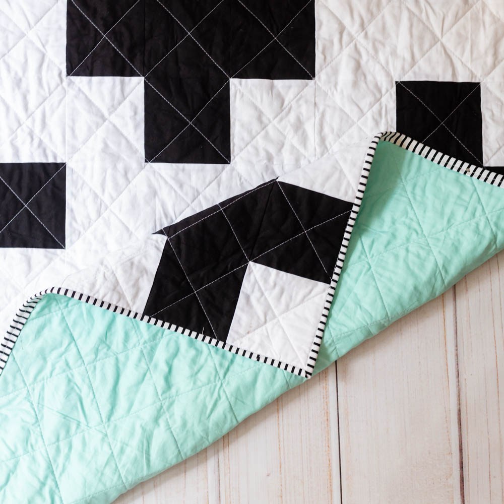 pictured: black and white cross pattern with mint green background
