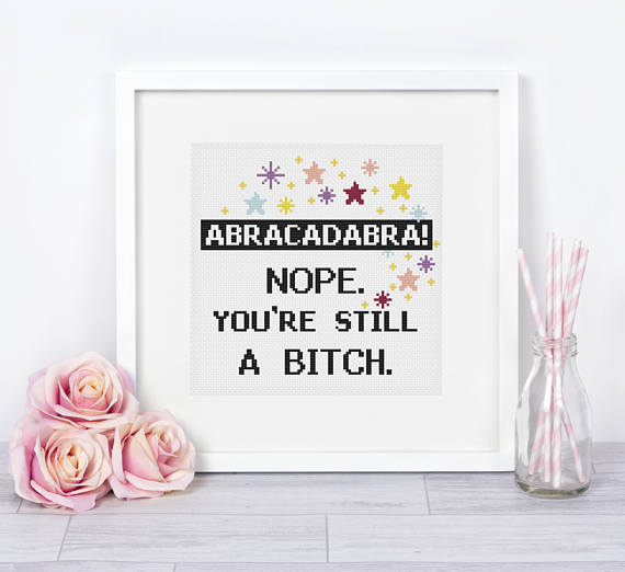 pictured cross stitch framed that reads abracadabra nope you're still a bitch