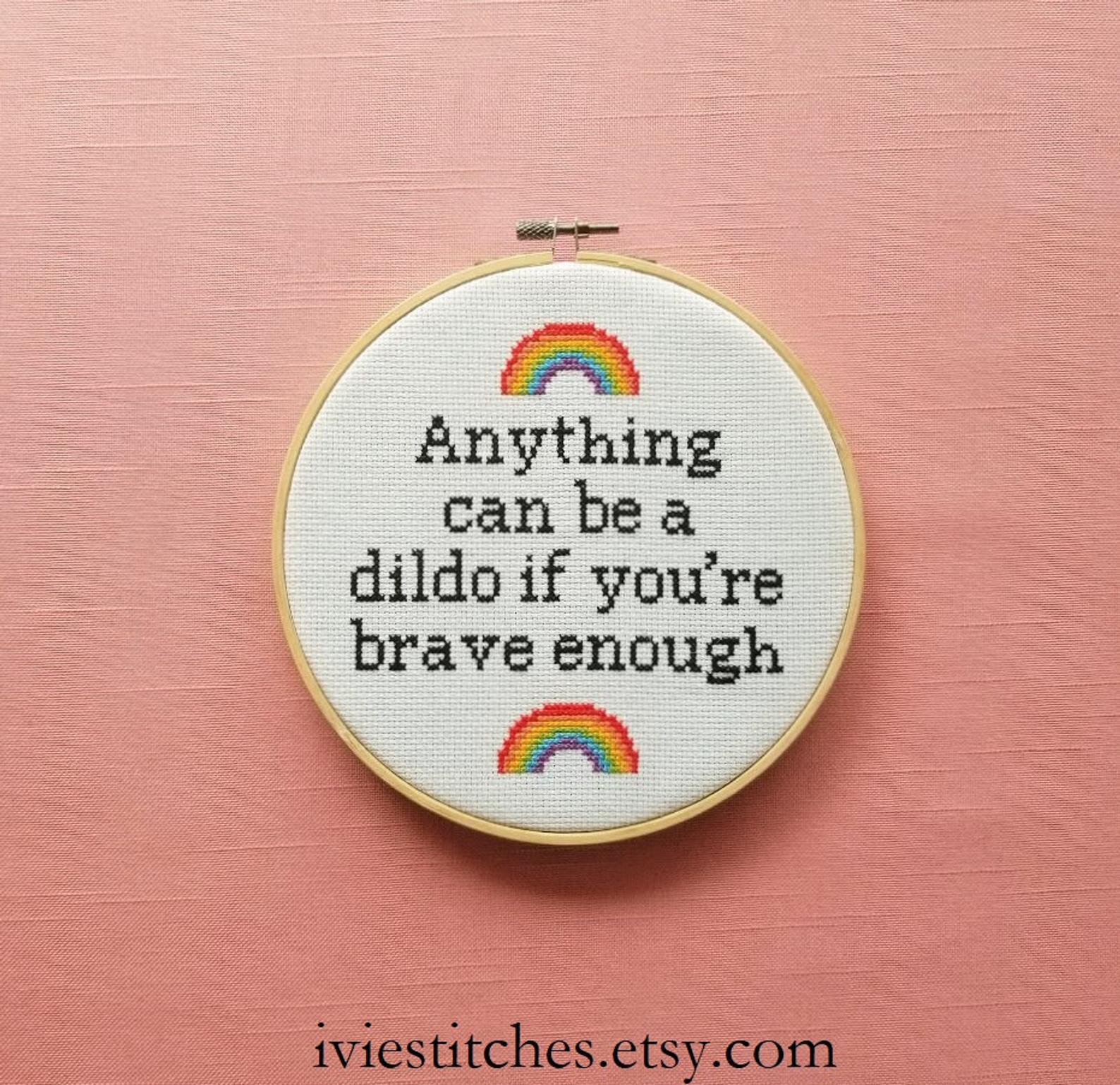 pictured cross stitch hoop with rainbows and words reading anything can be a dildo if you're brave enough