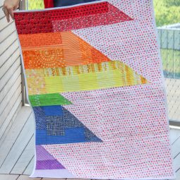 Scrappy Easy Rainbow Quilt Pattern and Tutorial: This easy sewing pattern is also a free sewing pattern. This beginner sewing tutorial is perfect for those who want to quilt a rainbow baby blanket to give as a gift. Click through for the free sewing pattern and a full tutorial. | www.sewwhatalicia.com
