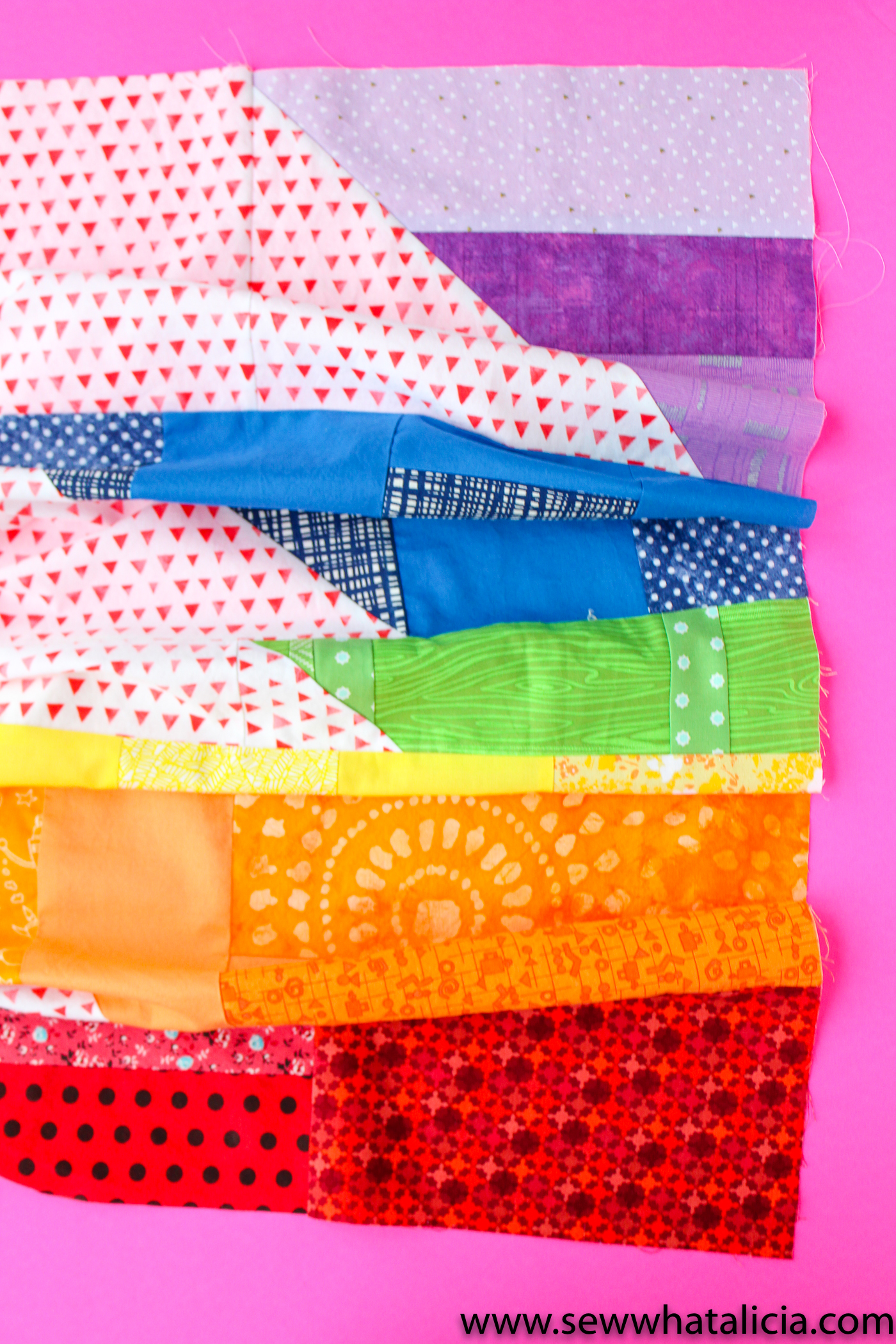 Scrappy Easy Rainbow Quilt Pattern and Tutorial: Pictured all the colored stripes pieced together for a finished quilt top. | www.sewwhatalicia.com